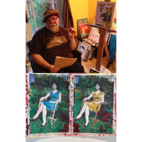 Man sitting with artwork displayed in front of him